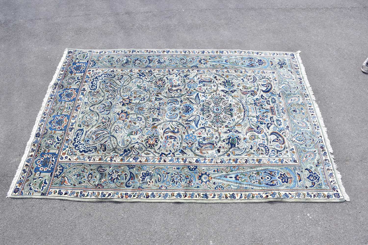 A blue ground wool carpet with floral geometric pattern, 190 x 295cm.