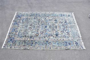 A blue ground wool carpet with floral geometric pattern, 190 x 295cm.