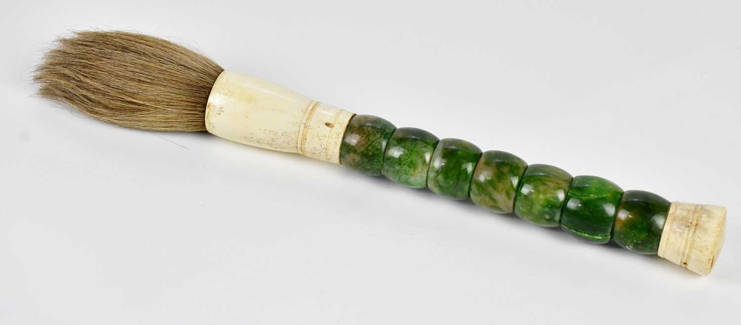 A green stone and bone fly whisk, 39cm.