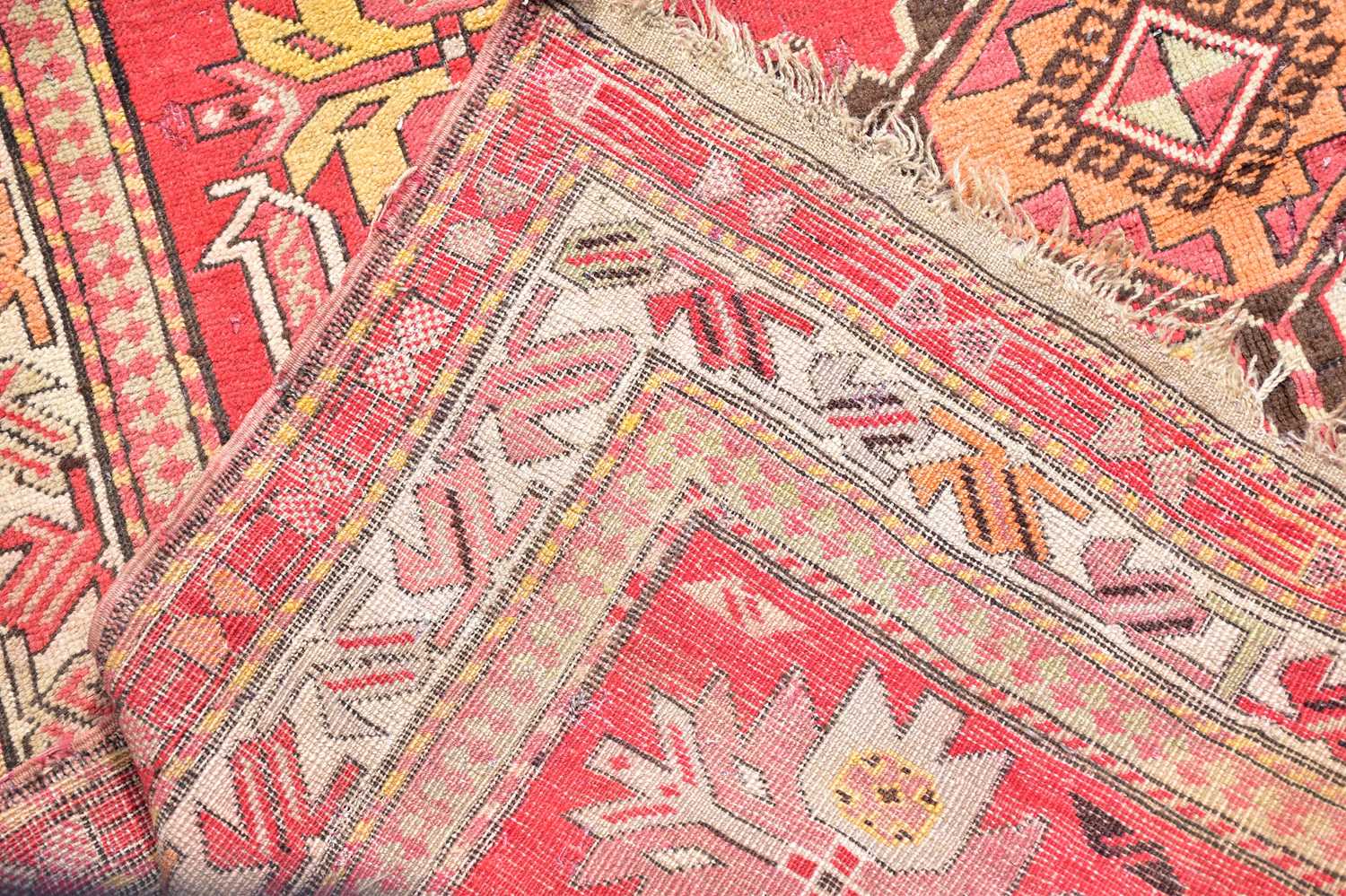 A red ground rug in the Bokhara style with stylised decoration and a further red and ivory ground - Image 3 of 4