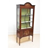 An Edwardian inlaid mahogany display cabinet with painted arched top and with a single glazed