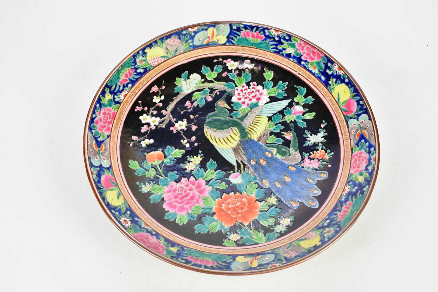 A Chinese Famille Rose porcelain wall plate, decorated with a peacock, diameter 36.5cm.
