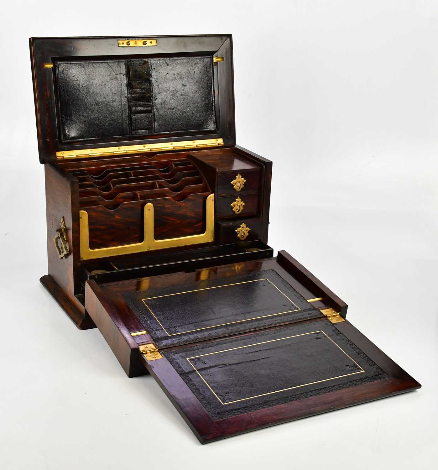 A 19th century brass bound rosewood stationery box, the hinged cover enclosing a fall front and