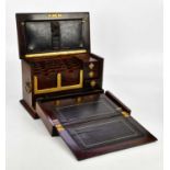 A 19th century brass bound rosewood stationery box, the hinged cover enclosing a fall front and