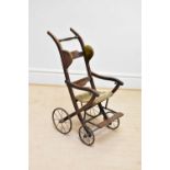 A late Victorian stained beech push chair.