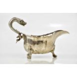 A good George III hallmarked silver sauceboat, with serpent handle and panelled body, on ball and