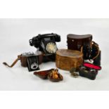 An assortment of collectors' items including a vintage bakelite telephone, a carved olive wood tea