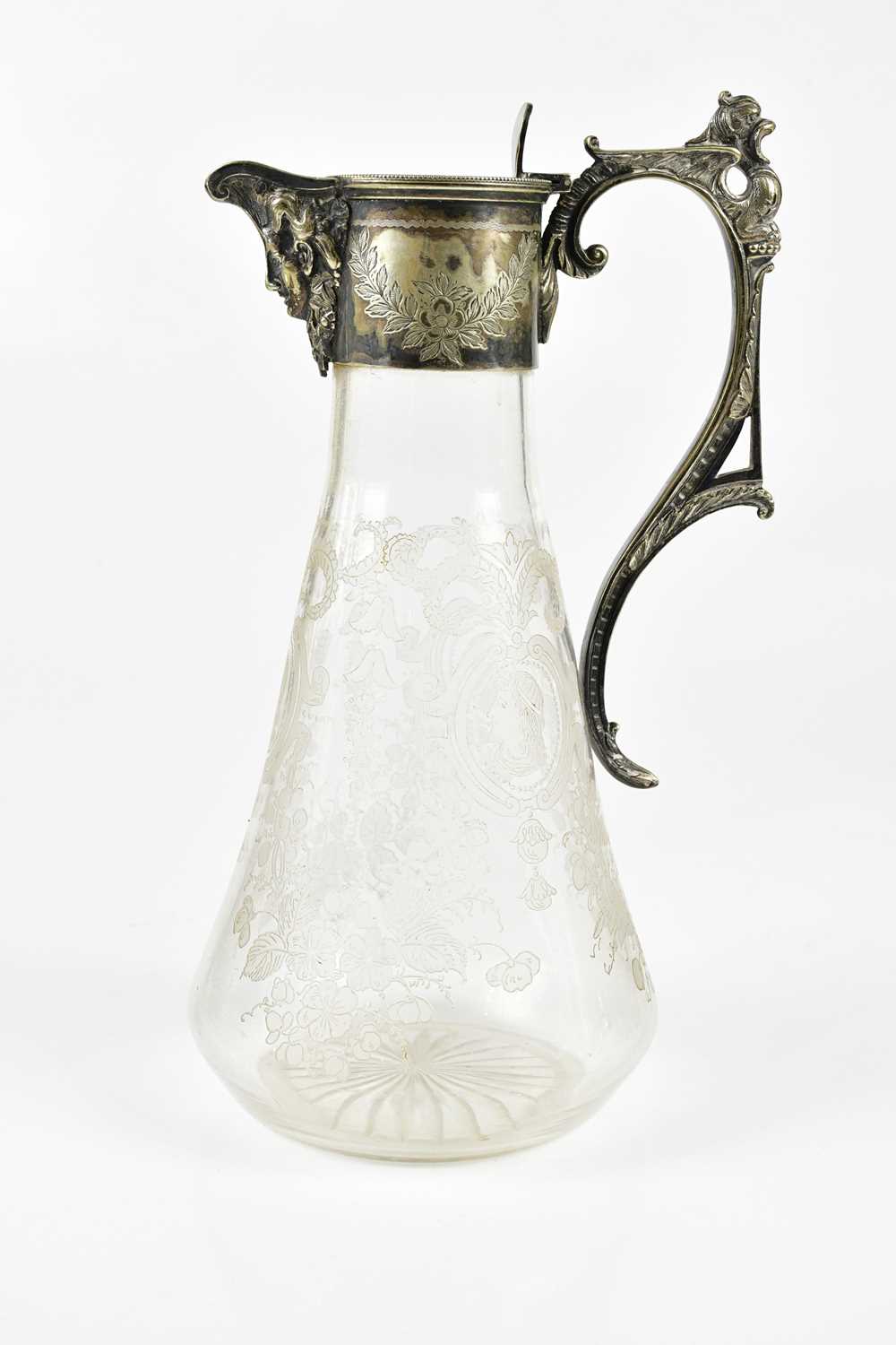 A late 19th/early 20th century etched glass claret jug with silver plated mounts and handle,