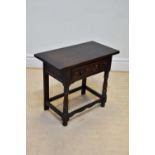 A modern oak side table with single drawer on bun feet, width 82cm, depth 42cm, height 70cm.