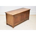 A 1950s oak blanket chest with linen fold decoration to the front, width 113cm, depth 43cm, height