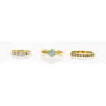 An 18ct dress ring set with a blue coloured stone, size N, a yellow metal diamond set five stone