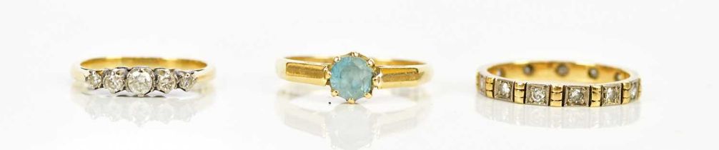 An 18ct dress ring set with a blue coloured stone, size N, a yellow metal diamond set five stone