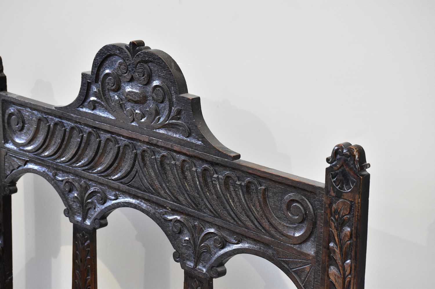 An early 20th century carved oak hall settle, with raised back and hinged seat, width 107cm, - Image 3 of 3