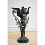 A modern decorative patinated metal figure of a standing cherub on marble base, height 90cm.