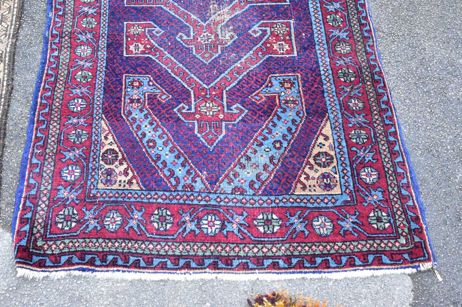 A Caucasian hand woven wool rug, worked with a geometric design against a purple ground, 180 x 97cm, - Image 4 of 5