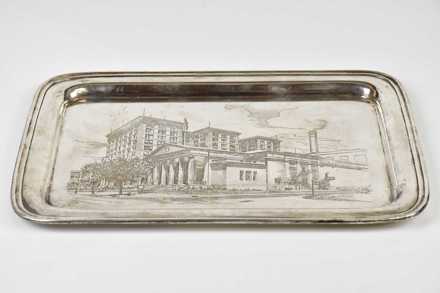 A sterling silver rectangular tray with engraved decoration of the N.G.R School House America,