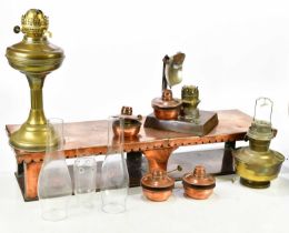 A copper warming plate stand with four burners, length 83cm, and a reflecting lamp and two brass oil