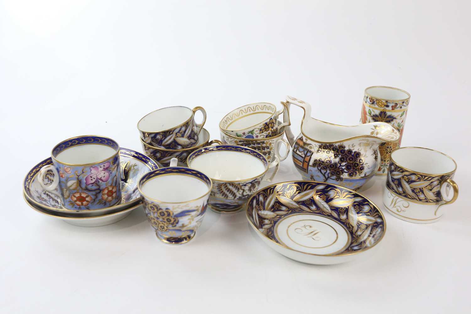 NEW HALL AND OTHERS; a collection of early 19th century Imari tea wares, comprising a trio