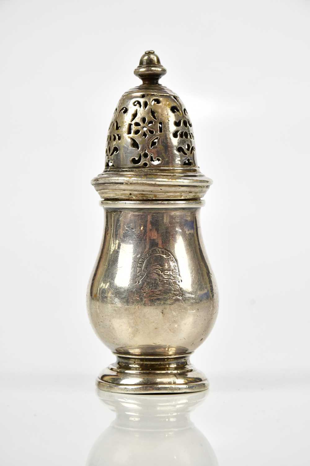 A George I hallmarked silver pepperette of baluster form, with cast acorn finial, the body