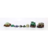 A collection of eight hardstone carved tortoises, including jade and malachite examples.