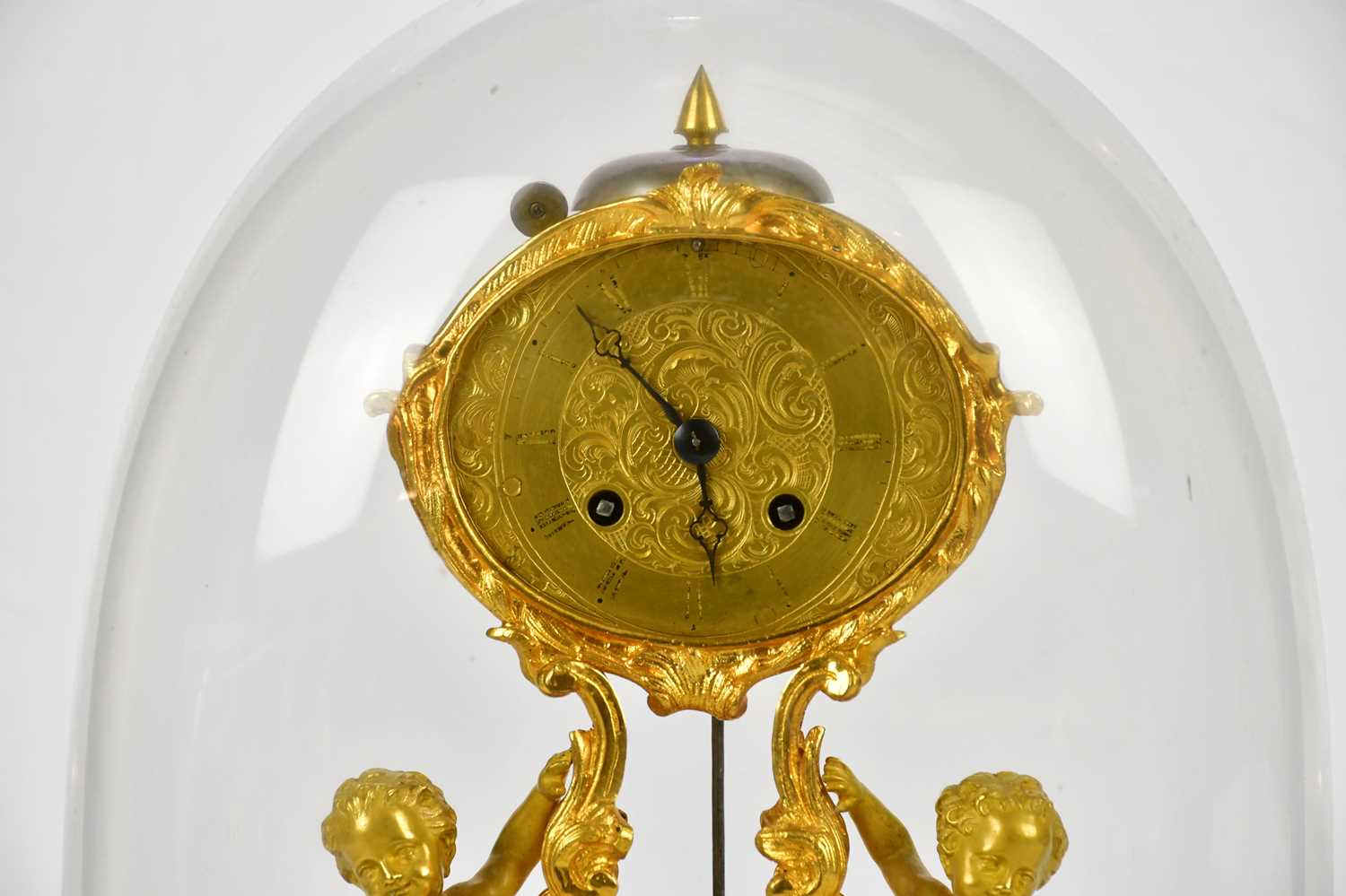 A late 19th century ormolu mantel clock, the oval dial set with Roman numerals on scrolling sabre - Image 2 of 5