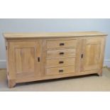 A modern limed oak sideboard with four drawers flanked by panelled cupboard doors, length 216cm,