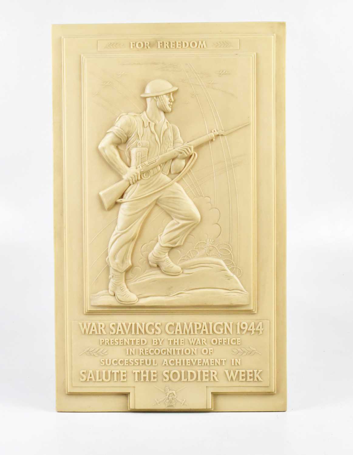 A WWII ivory coloured bakelite wall plaque, "War Savings Campaign 1944, presented by the War