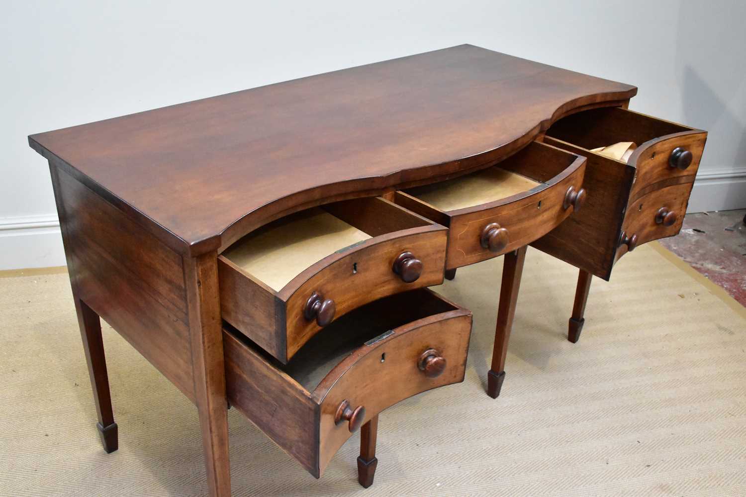 A late George III serpentine mahogany sideboard with three short drawers and one deep drawer on - Image 3 of 4