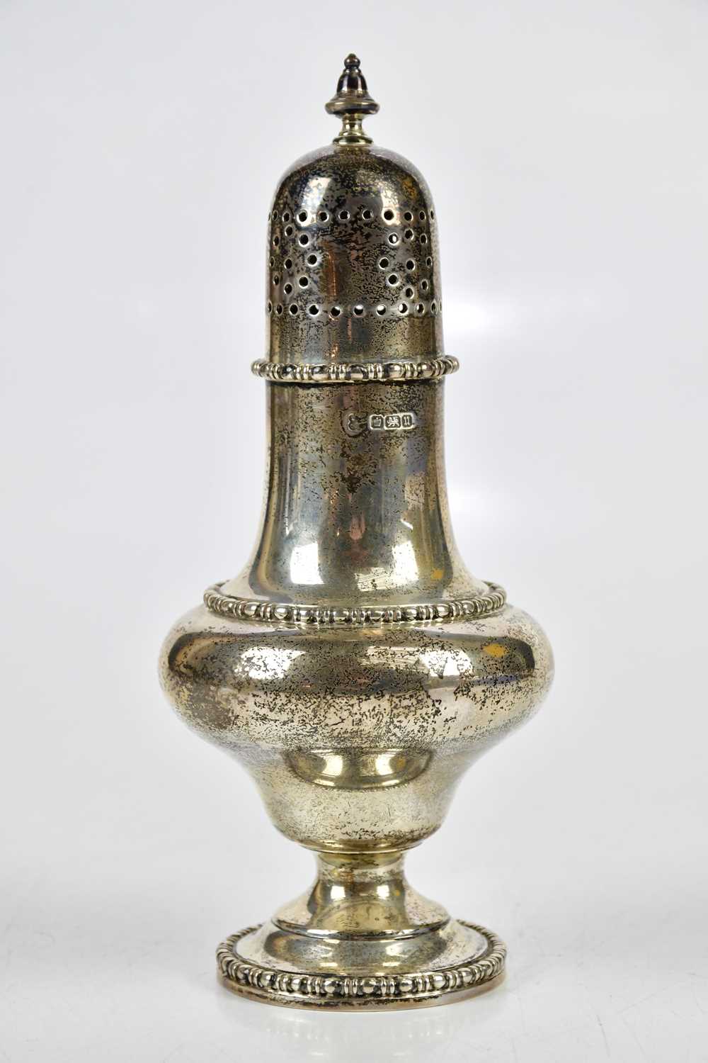 A George V hallmarked silver sugar caster with cast beaded rims, Sheffield 1912, approx 7ozt/218g.