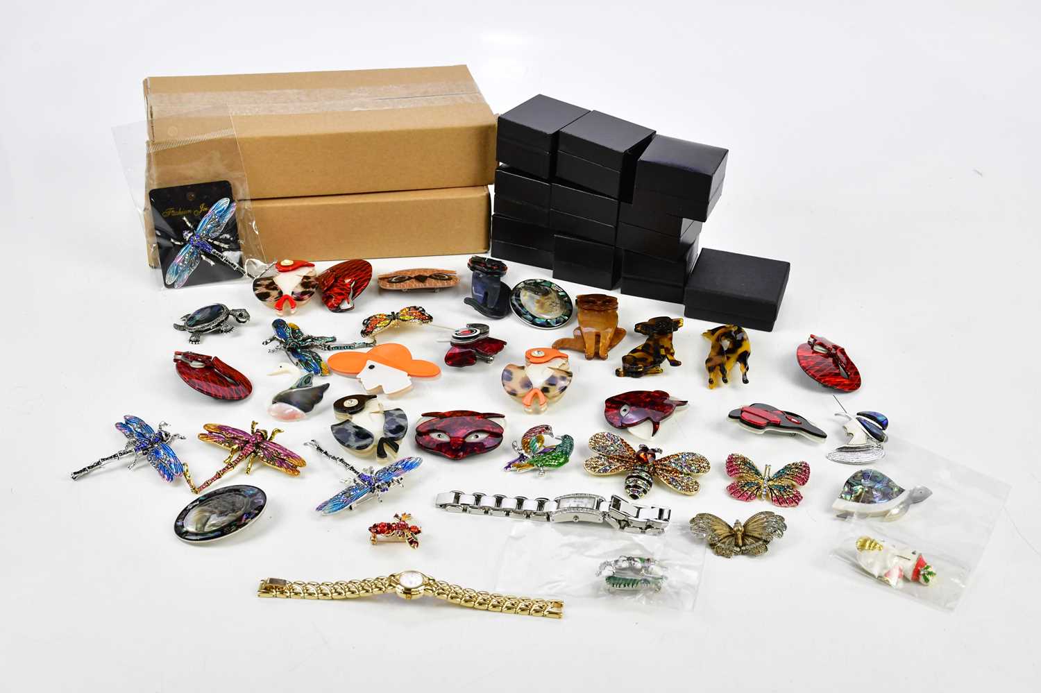 A collection of modern costume jewellery including various bakelite Art Deco style brooches,