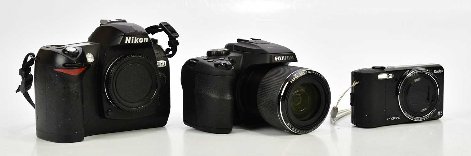 Three digital cameras, comprising a Nikon D70, a Fujifilm Finepix Sl bridge camera and a Kodak