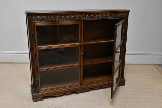 A reproduction carved oak two door bookcase, height 99cm, width 117cm, depth 26cm. - Image 2 of 4