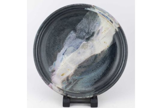 A stoneware charger covered in mottled black glaze with polychrome pours, painted signature (' - Image 2 of 5