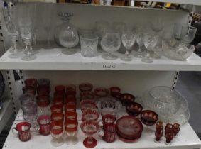 A group of sundry glassware, including cranberry glass, large cut glass bowls, cut glass champagne