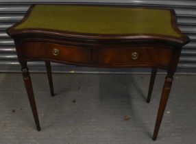 A reproduction mahogany two drawer games table, with gilt tooled leather inset top, width 90cm.