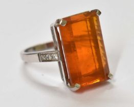 An 18ct white gold ring, set with large central Mexican fire opal flanked by three small diamonds,