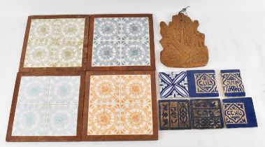 A set of three Hebrew tiles, two further Hebrew tiles, a blue and white tile, a ceramic wall hanging