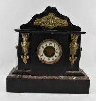 A late Victorian slate mantel clock set with brass panels, height 51cm, width 49cm.