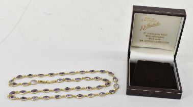 An 18ct yellow gold amethyst necklet comprising forty-two oval individually set stones, length 60cm,