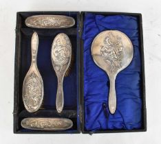 JAMES DEAKIN & SONS; a cased George V hallmarked silver five piece dressing table set comprising two