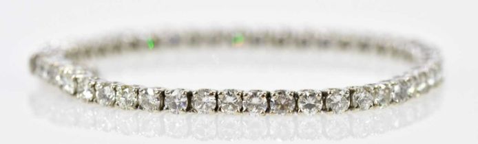 An 18ct white gold diamond tennis bracelet set with forty-eight round brilliant cut stones totalling