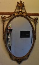 A reproduction gilt framed wall mirror with urn and swag decoration, height 104cm.