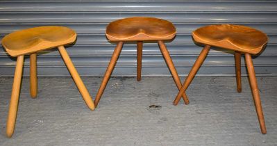 A set of three mid century saddle seat stools, height 46cm, width 38.5cm.