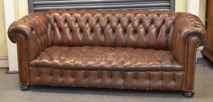 A brown button upholstered leather Chesterfield sofa, width 200cm.