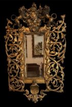 A 19th century elaborately gilt framed wall mirror, with shield decoration flanked by pair of lions,