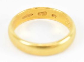 A yellow metal wedding band, size R, approx 7.2g.