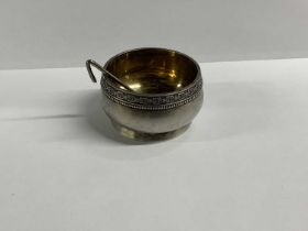 A Russian 875 grade silver circular open salt, with gilt wash interior and matching spoon,