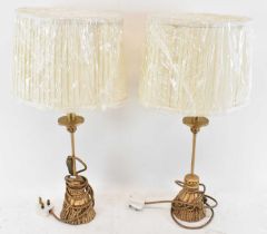 A pair of modern gilt effect table lamps with white shades, height to top of fitment 40.5cm.