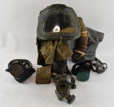 A group of three WWII gas masks and a baby's gas mask (4).