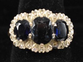 An 18ct yellow gold sapphire and diamond lady's dress ring, set with three large sapphires and